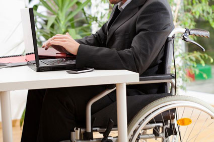 Man in Wheelchair Working on Laptop