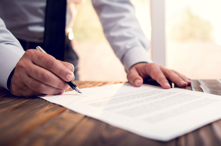 Businessman Signing An Official Document