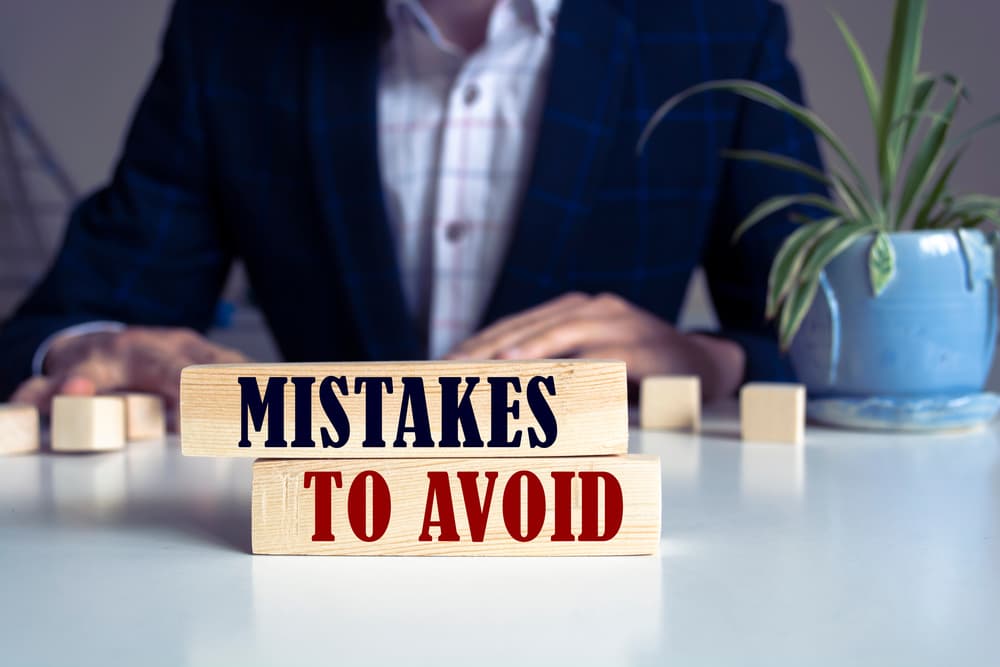 Mistakes To Avoid text written on wooden blocks lying on a table