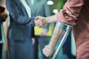 Injured person shaking attorneys hand