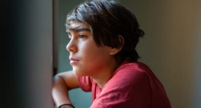 Boy looking through window