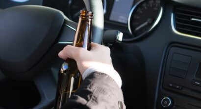Man in car with open container
