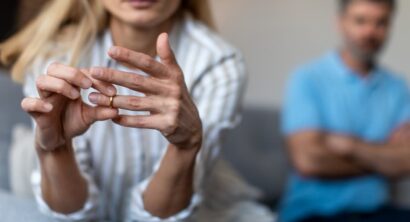 Unhappy middle aged lady takes off ring, ignoring man in a divorce process.