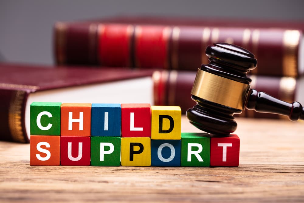 Child Support Colorful Block With Hammer Over Wooden Desk In Courtroom