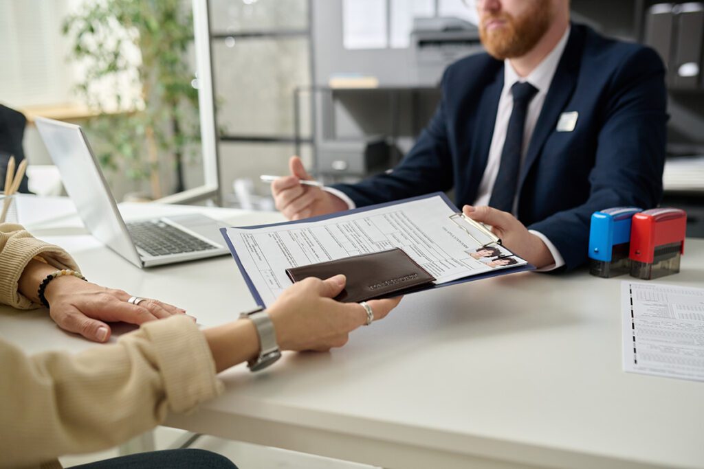 Applicant submitting visa application to the counselor 