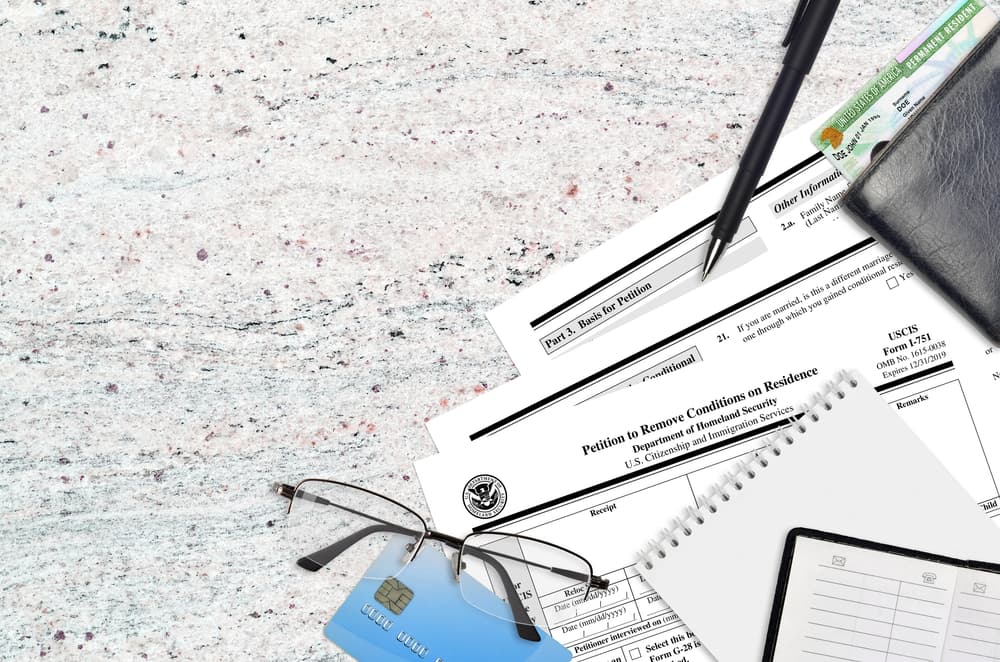 USCIS form I-751 Petition to remove conditions on residence lies on flat lay office table and ready to fill.