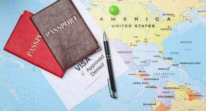 Passports and pen on map. Approved American visa