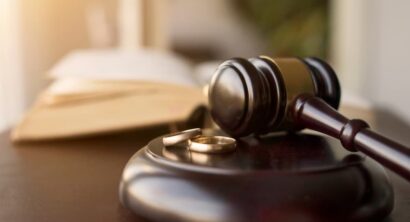 Judge gavel and wedding rings for divorce proceedings.