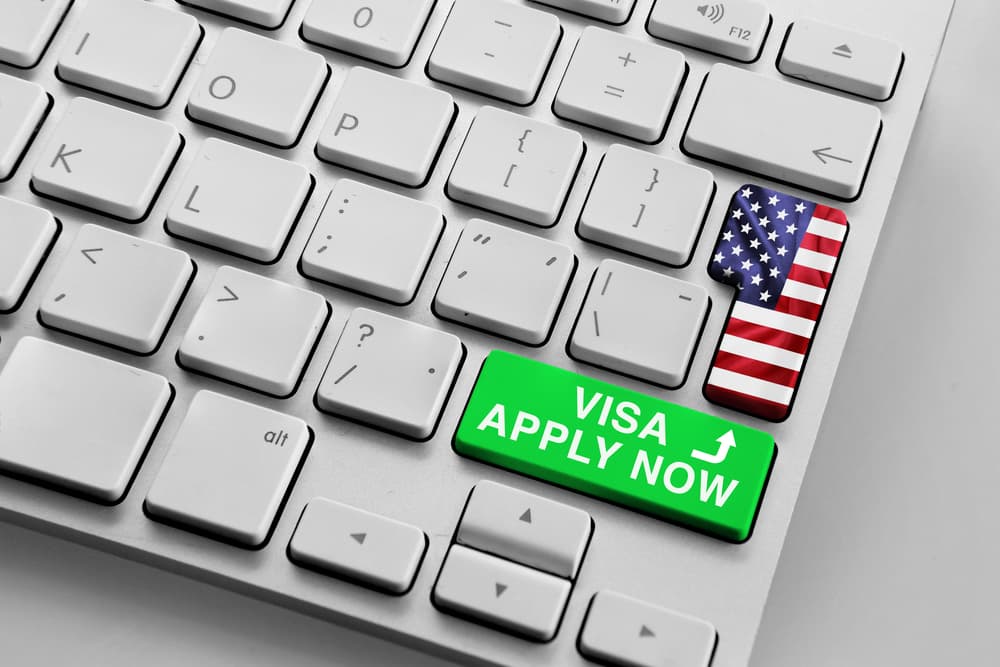 Computer keyboard with u.s flag and apply now for visa button
