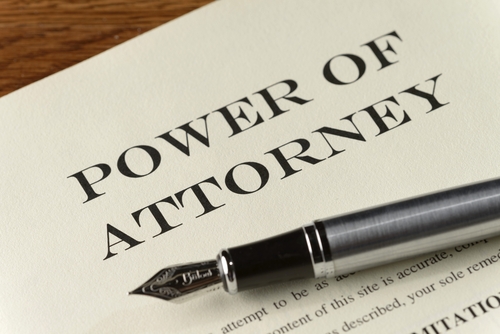 Close-up of a legal document titled “Power of Attorney” with a fountain pen resting on the page, symbolising legal authorization.