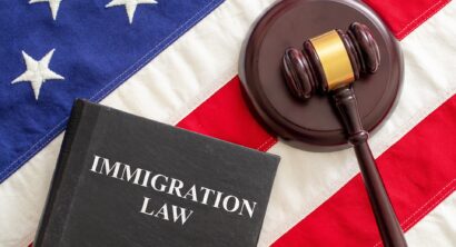 Judge gavel and Immigration Law book on United States of America flag
