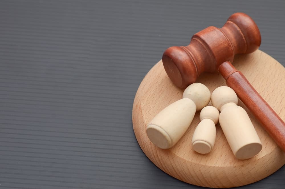 a gavel and a family of wooden figures