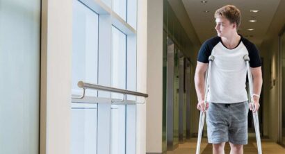 Young man walking on crutches