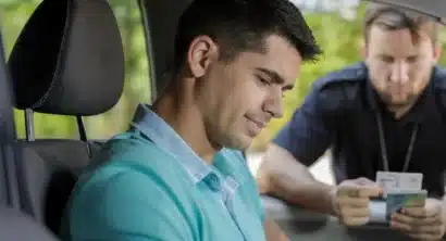 cop looking over a driver's license